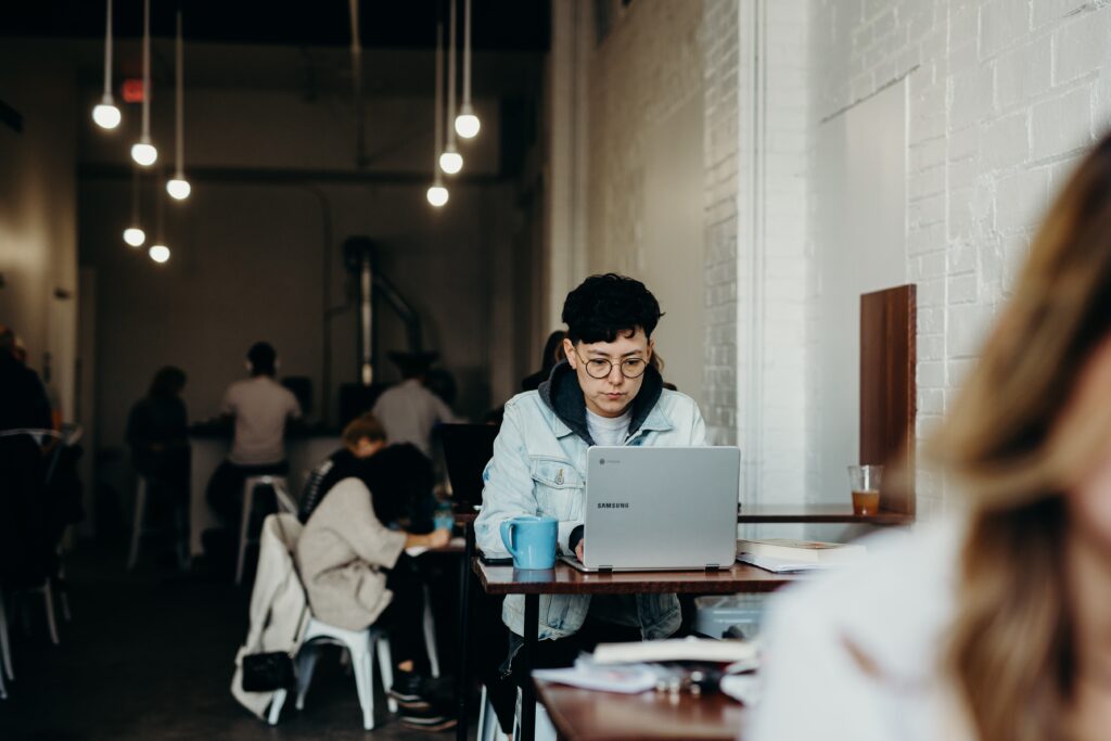 Person working at their Samsung laptop in a coffee shop