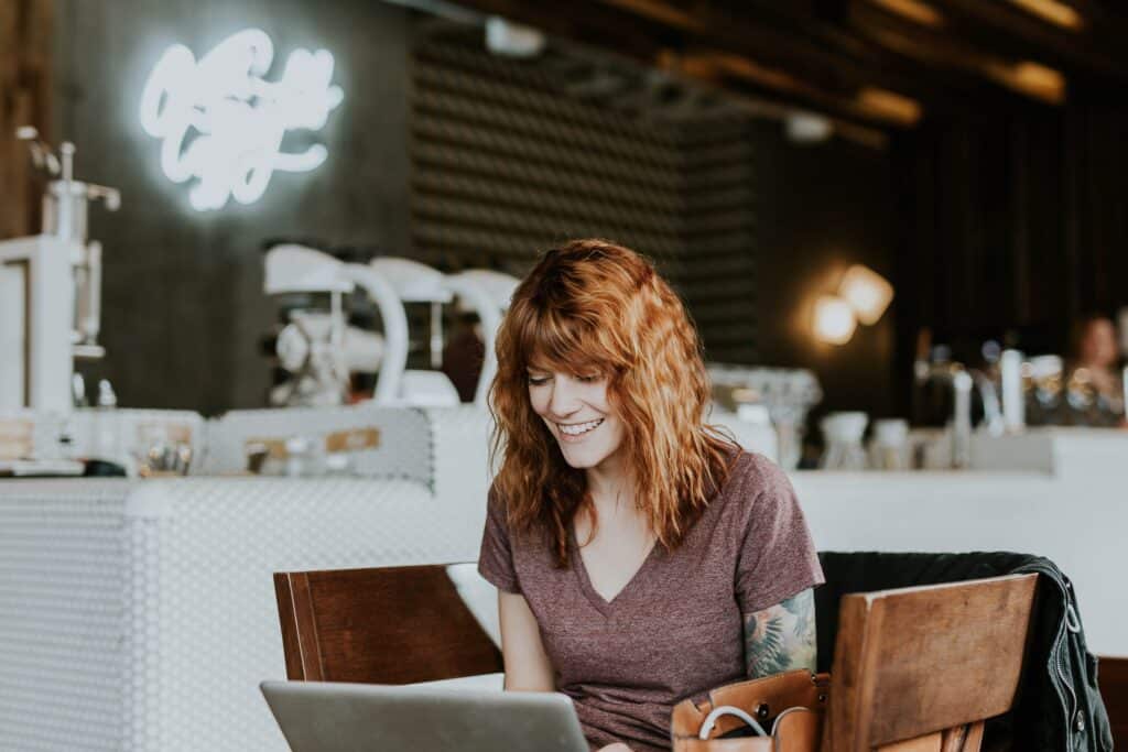 Woman working at her laptop in a coffee shop