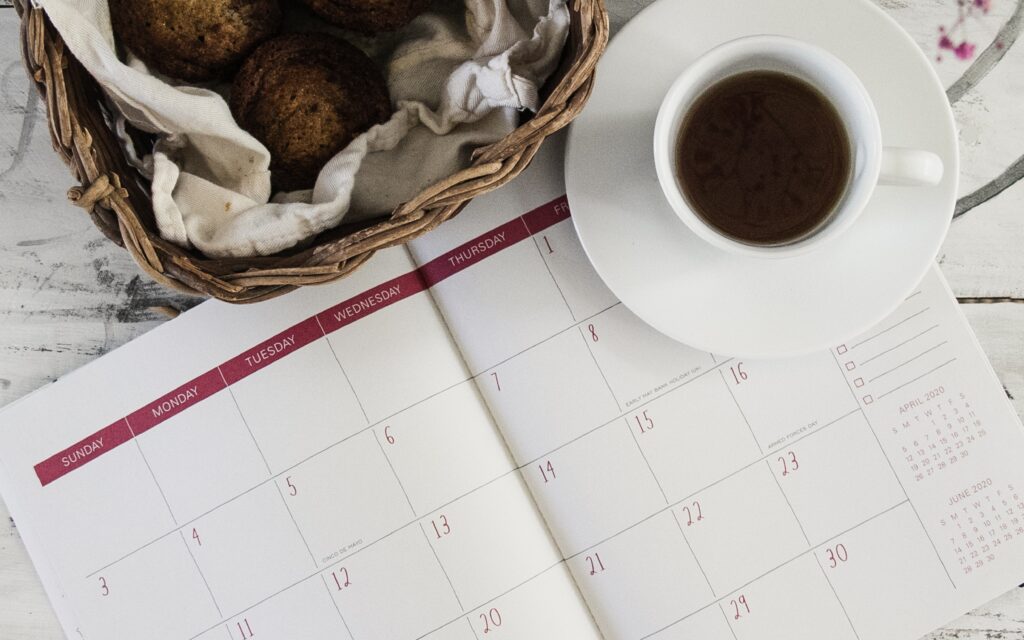 Close up of a cup of coffee resting on a calendar book