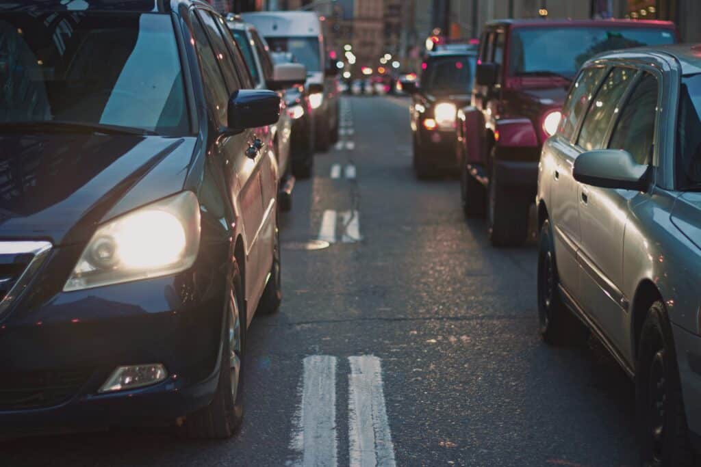 Line of cars sitting in traffic after sunset