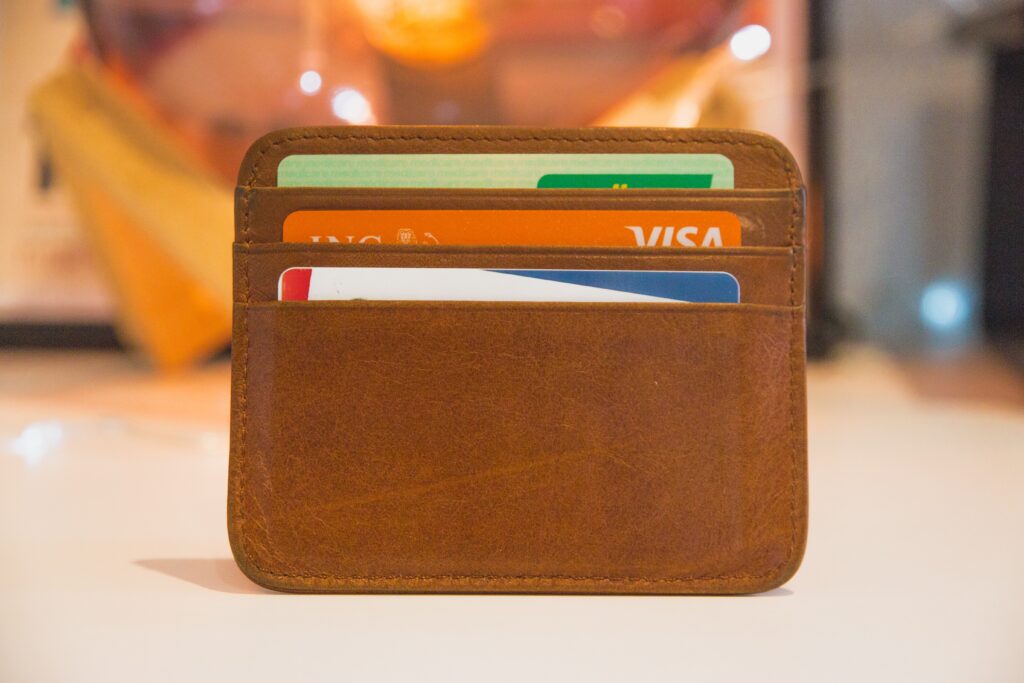 Brown wallet standing up with 3 cards showing