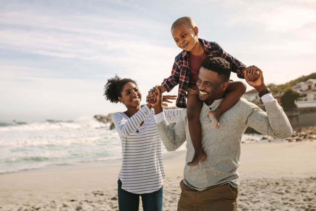 A happy family walking on the beach