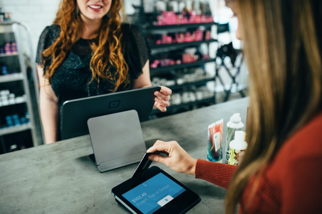 Woman inserting her card into a card reader at a store