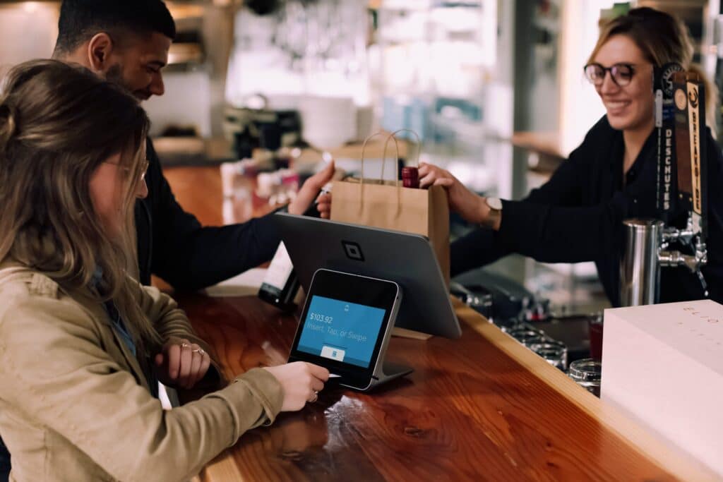 Man and woman checking out at a register