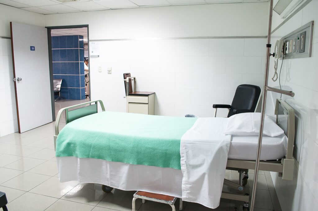 Empty hospital bed in a patient room