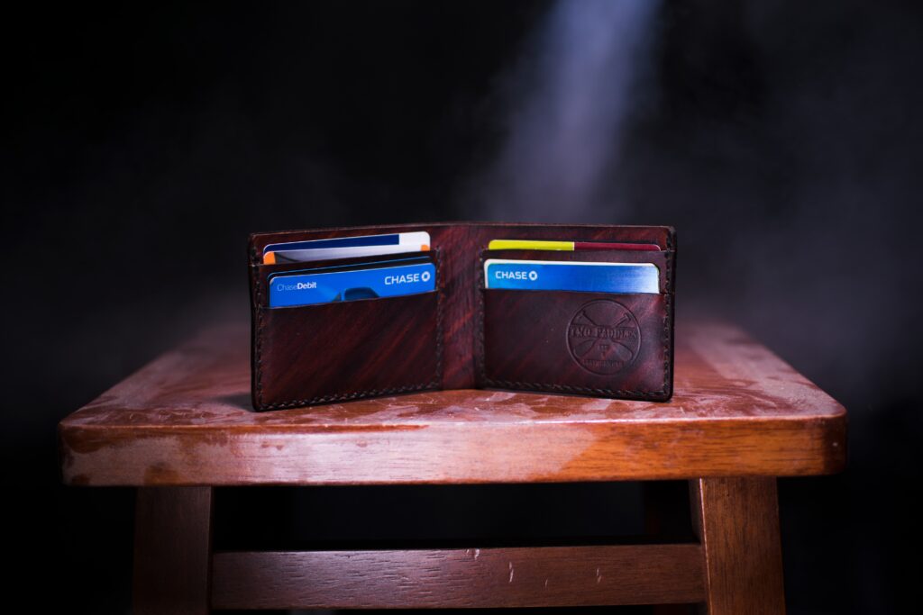 Open wallet with cards standing up on a table under a bright light