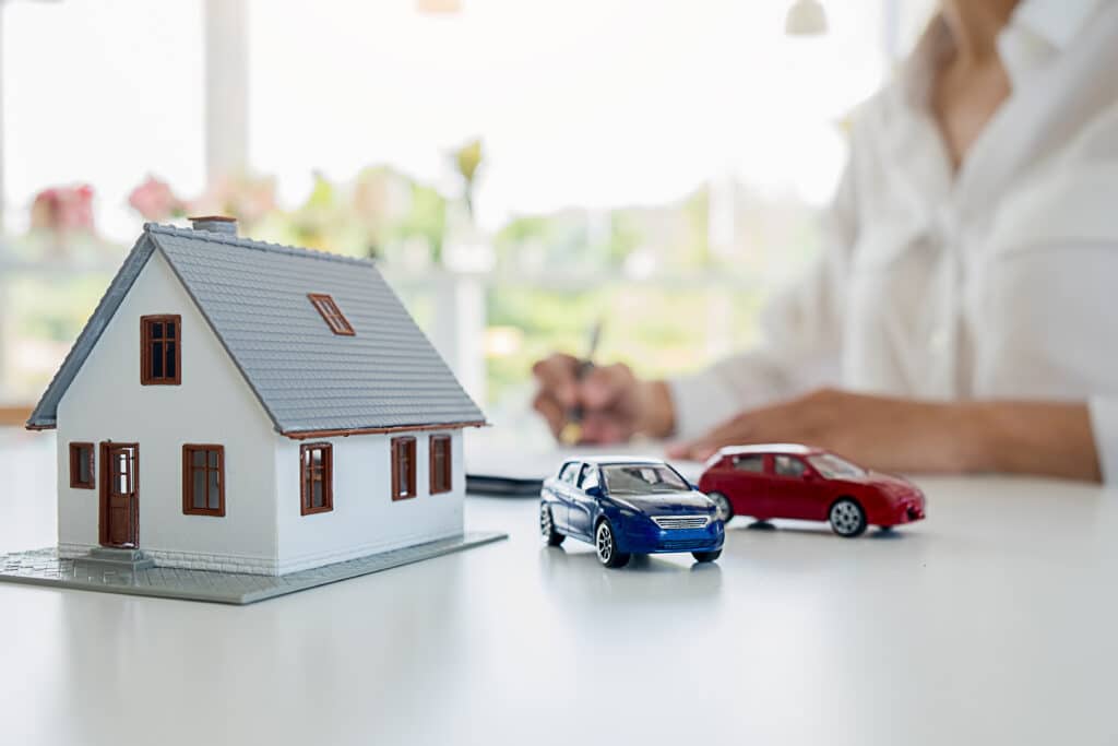 A miniature home and cars on a desk