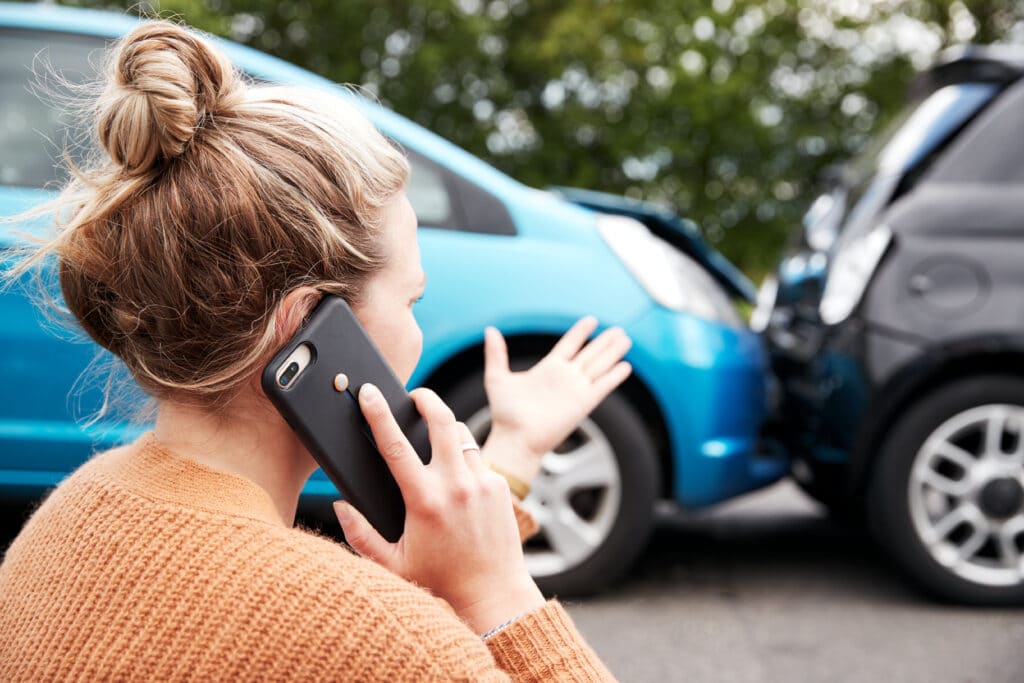 A woman talks on the phone after being rear ended