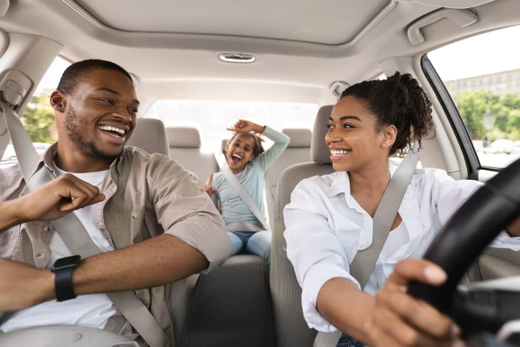 Happy family rides in a car together.