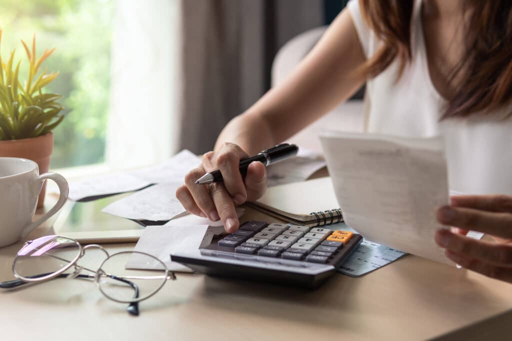 A woman uses a calculator.