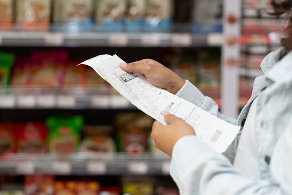 A shopper reviews their receipt.