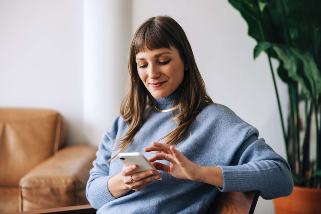 A woman uses her smart phone.