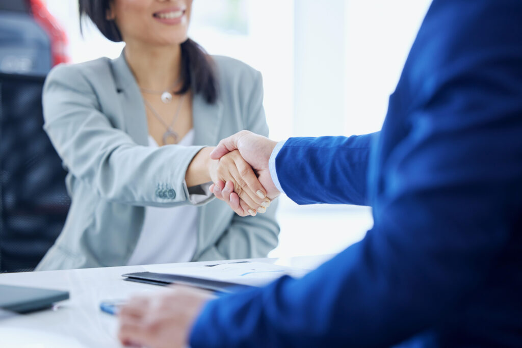 customer shaking hands with insurance agent