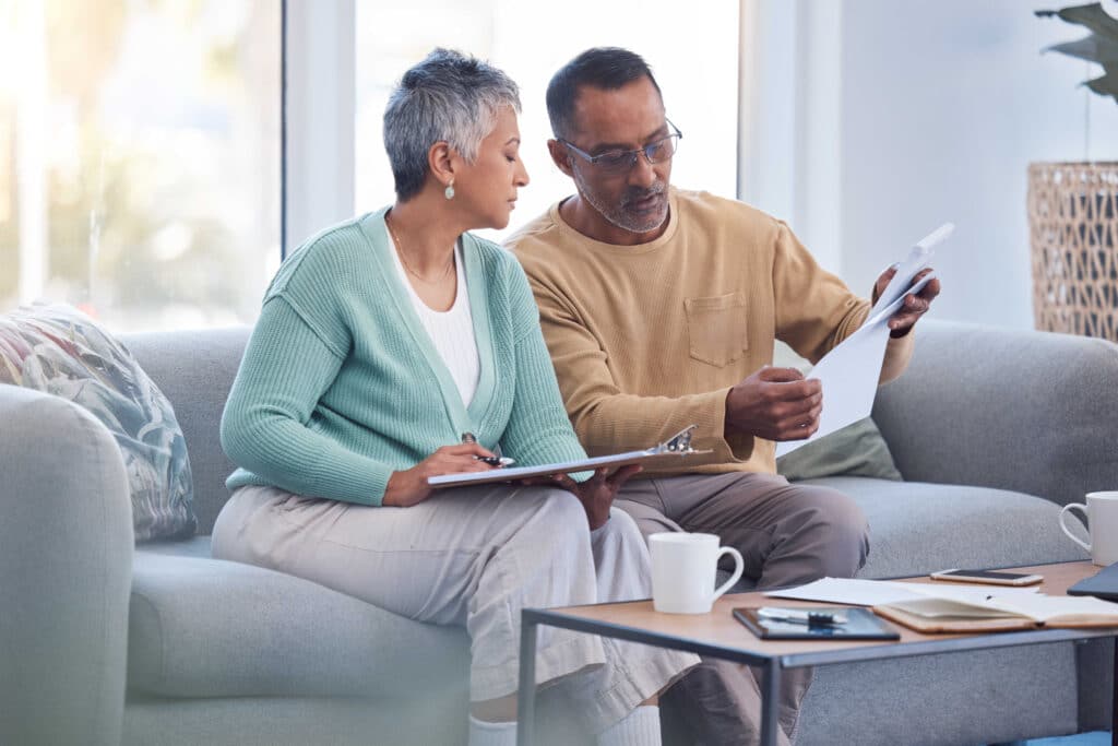 A couple reviews a life insurance document together.