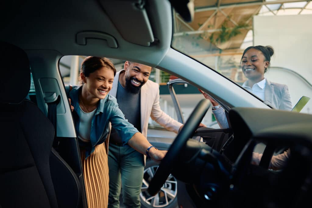 A couple looks at a new car together